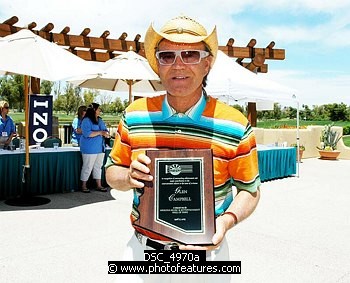 Photo of Glen Campbell with presentation for his induction in Arizona Music nd Entertainment Hall Of Fame at the 9th Alice Cooper Golf Tournament in Scottsdale to benefit his Solid Rock Foundation Charity, May 2nd 2005. phoo by Chris walter/Photofeatures. , reference; DSC_4970a