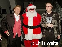 Robin Zander and Rick Nielsen of Cheap Trick with Santa Claus at Alice Cooper's Christmas Pudding show for his Solid Rock Foundation Charity at Dodge Theatre in Phoenix, Arizona, December 18th 2004. Photo by Chris Walter/Photofeatures.