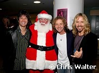 Michael Cartellone, Jack Blades and Tommy Shaw of Damn Yankees with Santa Claus. First appearance of Damn Yankees in 10 years. at Alice Cooper's Christmas Pudding show for his Solid Rock Foundation Charity at Dodge Theatre in Phoenix, Arizona, December 18th 2004. Photo by Chris Walter/Photofeatures.