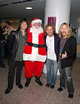 Michael Cartellone, Jack Blades and Tommy Shaw of Damn Yankees with Santa Claus. First appearance of Damn Yankees in 10 years. at Alice Cooper's Christmas Pudding show for his Solid Rock Foundation Charity at Dodge Theatre in Phoenix, Arizona, December 18th 2004. Photo by Chris Walter/Photofeatures.