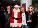 Michael Cartellone, Jack Blades and Tommy Shaw of Damn Yankees with Santa Claus. First appearance of Damn Yankees in 10 years. at Alice Cooper's Christmas Pudding show for his Solid Rock Foundation Charity at Dodge Theatre in Phoenix, Arizona, December 18th 2004. Photo by Chris Walter/Photofeatures.