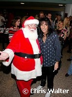 Alice Cooper and Santa Claus at Alice Cooper's Christmas Pudding show for his Solid Rock Foundation Charity at Dodge Theatre in Phoenix, Arizona, December 18th 2004. Photo by Chris Walter/Photofeatures.